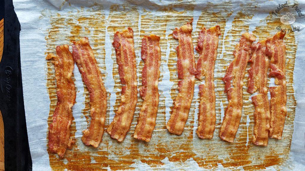 Bacon on a parchment lined baking sheet.