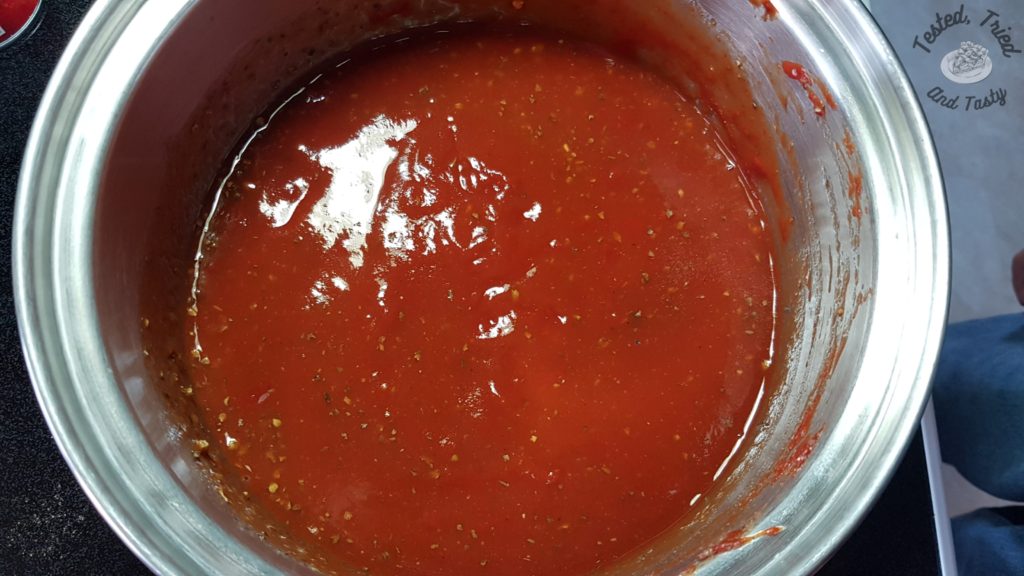 Homemade pizza sauce in a saucepan.