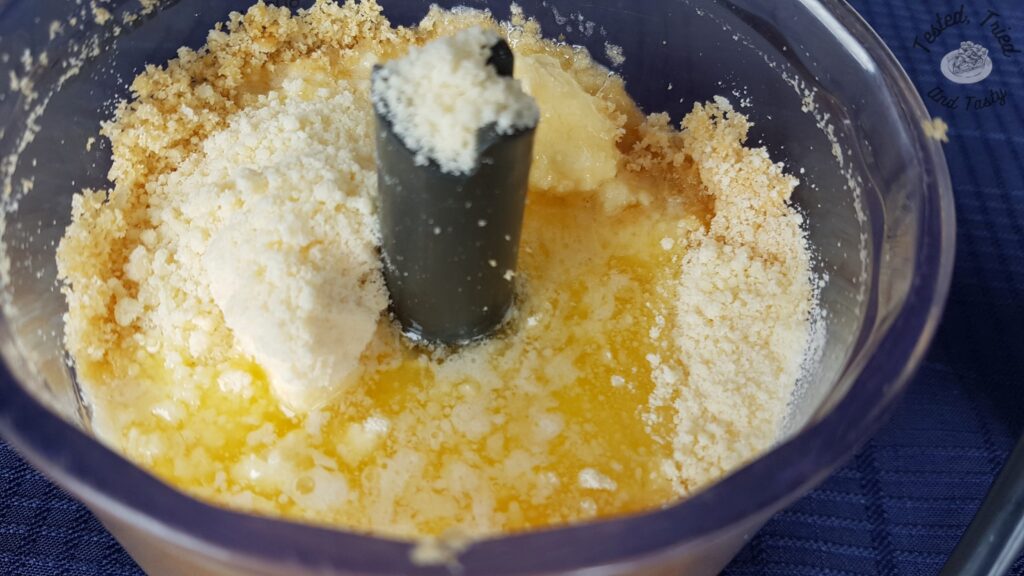 Butter and parmesan added to crushed Ritz crackers.