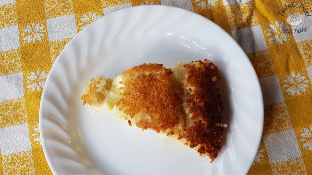 Impossible Pie on a white plate on a yellow and white checkered tablecloth