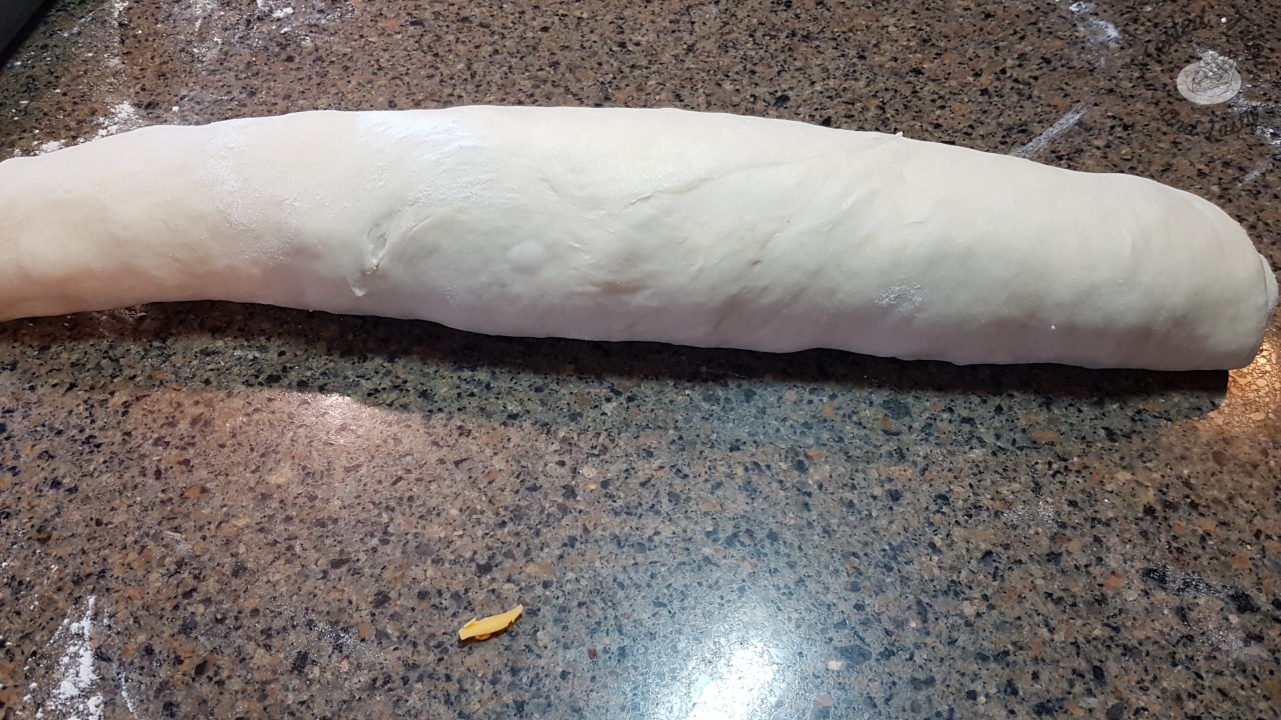 dough ready to cut into sections on granite countertop
