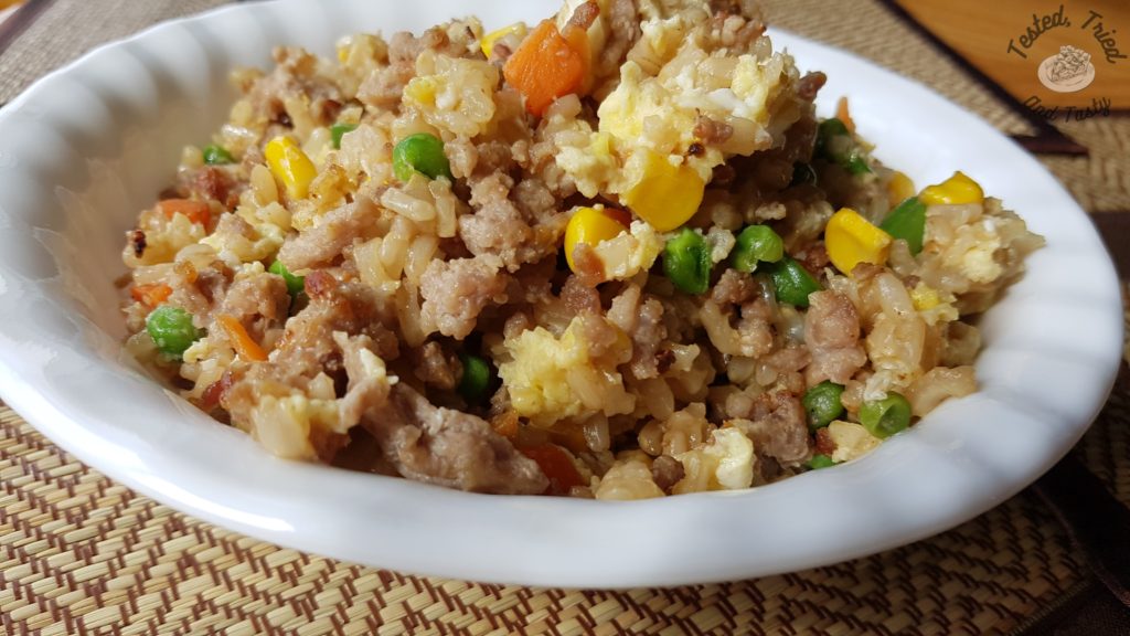 Easy pork fried rice in a white bowl on a bamboo placemat