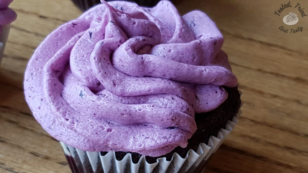 blueberry buttercream on a marble cupcake