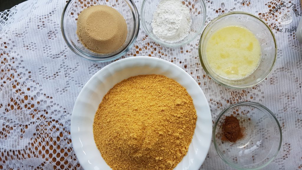 ingredients for the graham wafer crust on a white lace tablecloth.