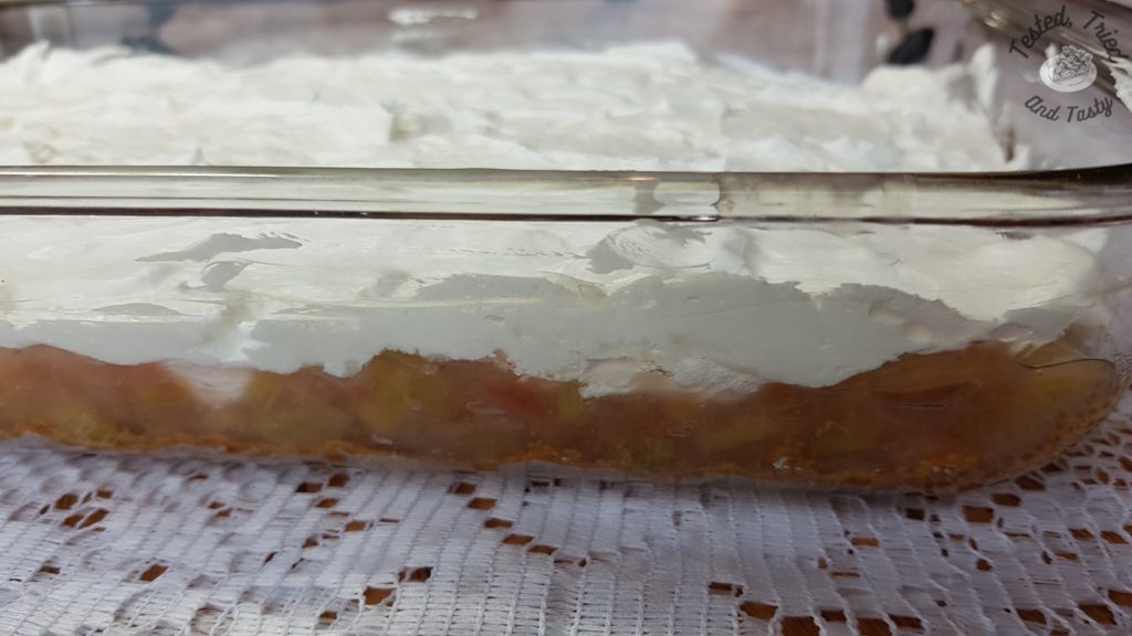Dream whip/mini marshmallow layer on top of rhubarb layer for rhubarb torte with pudding.