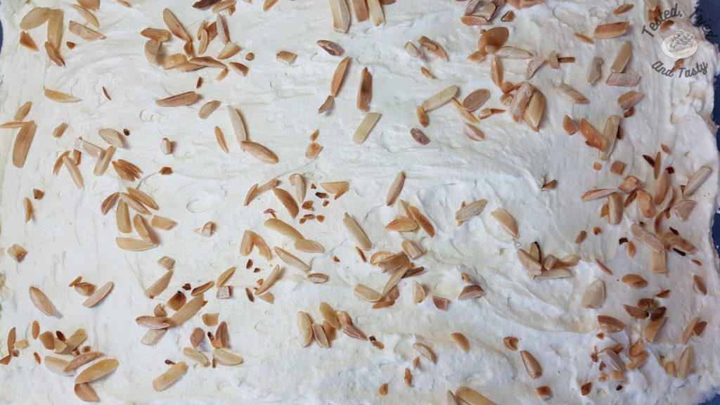 Toasted slivered almonds on the top of the pistachio pudding dessert.