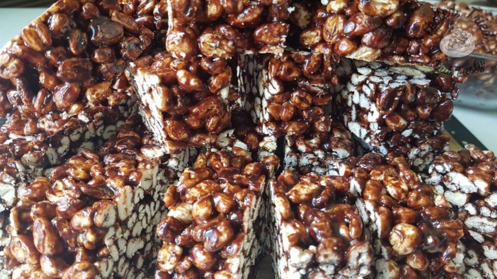 Puffed wheat squares on a wooden cutting board.