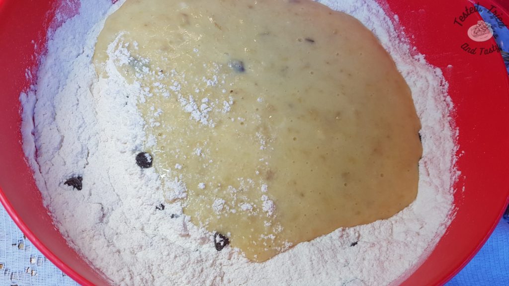 Mixing the wet and dry ingredients together for chocolate chip banana muffins.