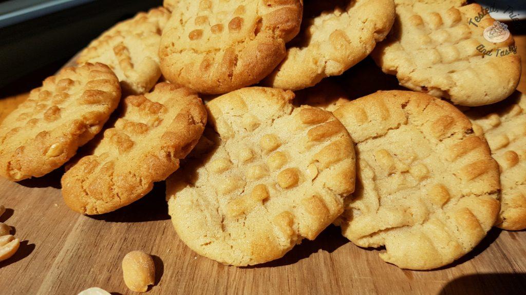 Peanut butter cookies recipe on a wooden cutting board.