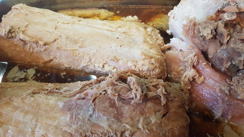 Cooked pork shoulder and pork loin ready to be shredded.