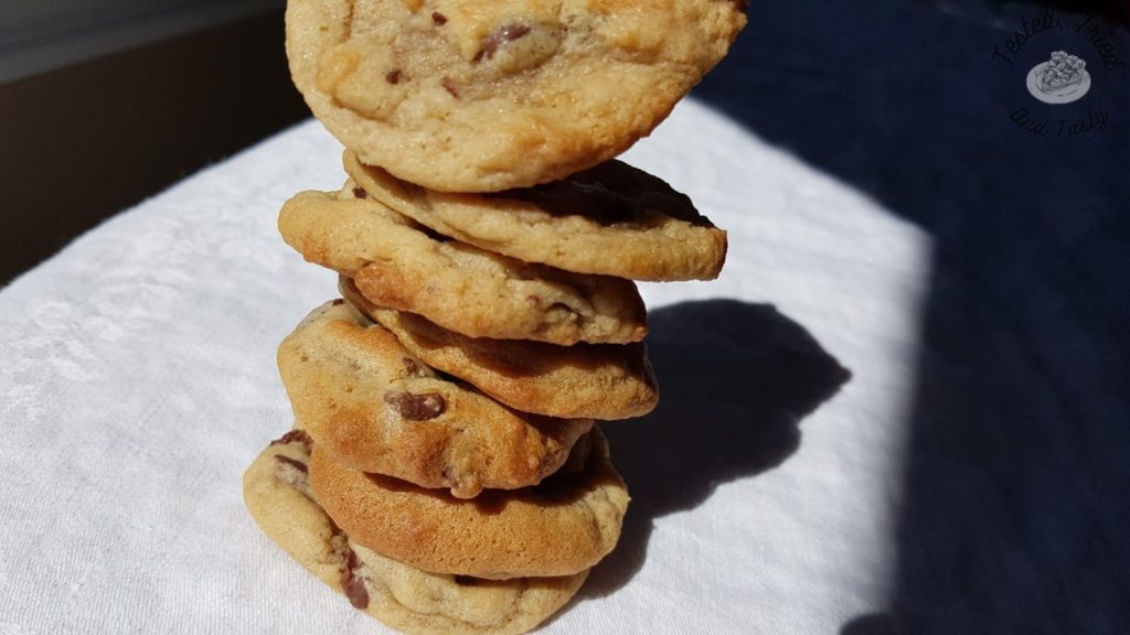 Chocolate chip cookies on a white tablecloth.