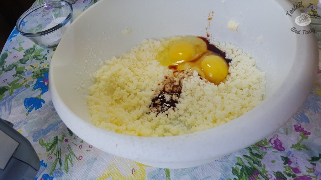 Eggs and vanilla added to the creamed butter and sugar.