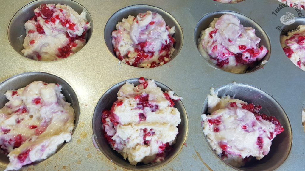 Raspberry White Chocolate Muffins in a muffin tin ready to be baked.