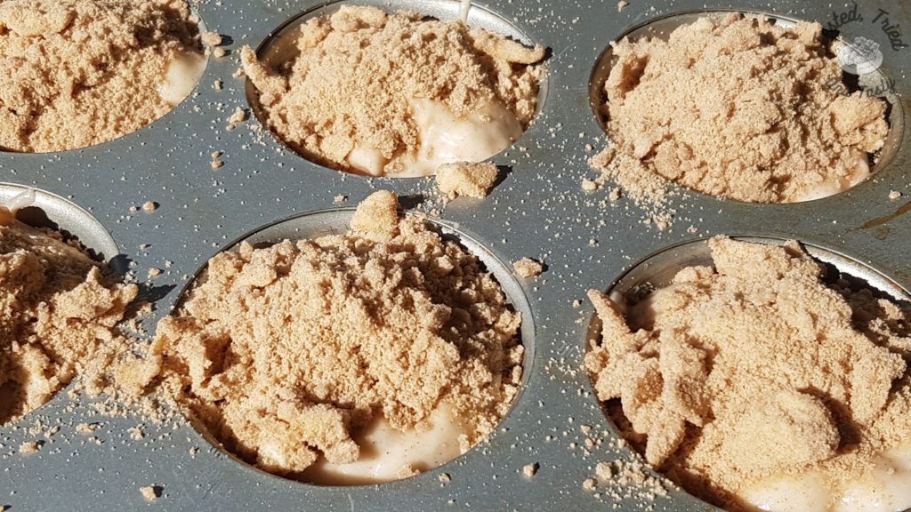 Streusel topping on apple cinnamon muffins.