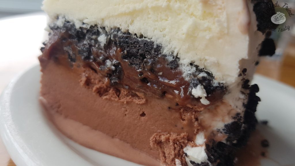 Close up of ice cream cake on a white plate.