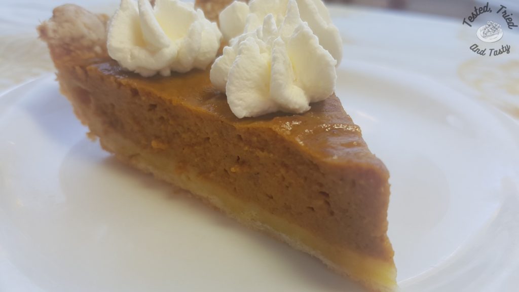 Traditional Thanksgiving pie with sweetened whipped cream.