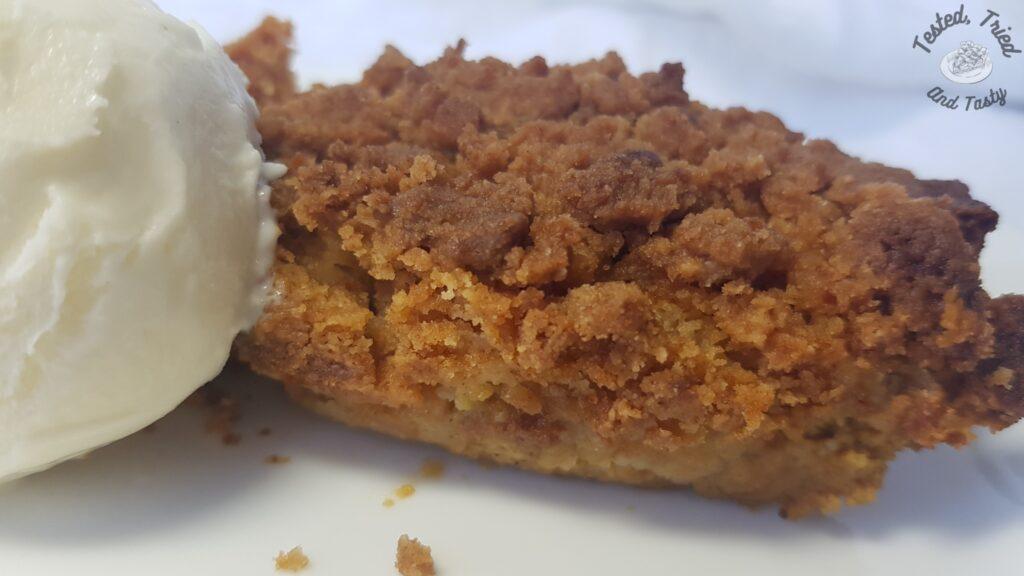 Pumpkin dessert with vanilla ice cream on a white plate.