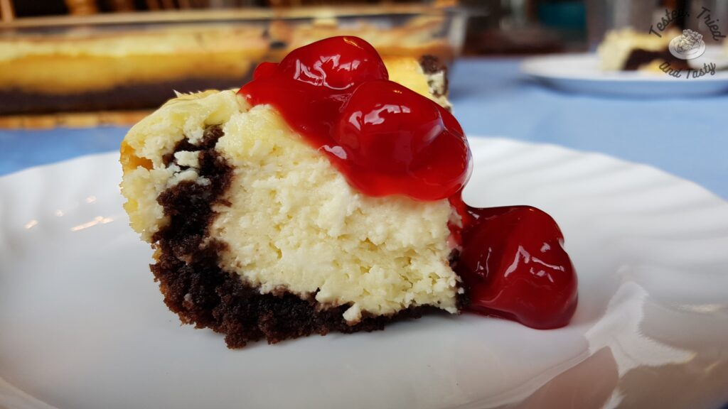 Black Forest cheesecake cake with cherry pie filling on top.