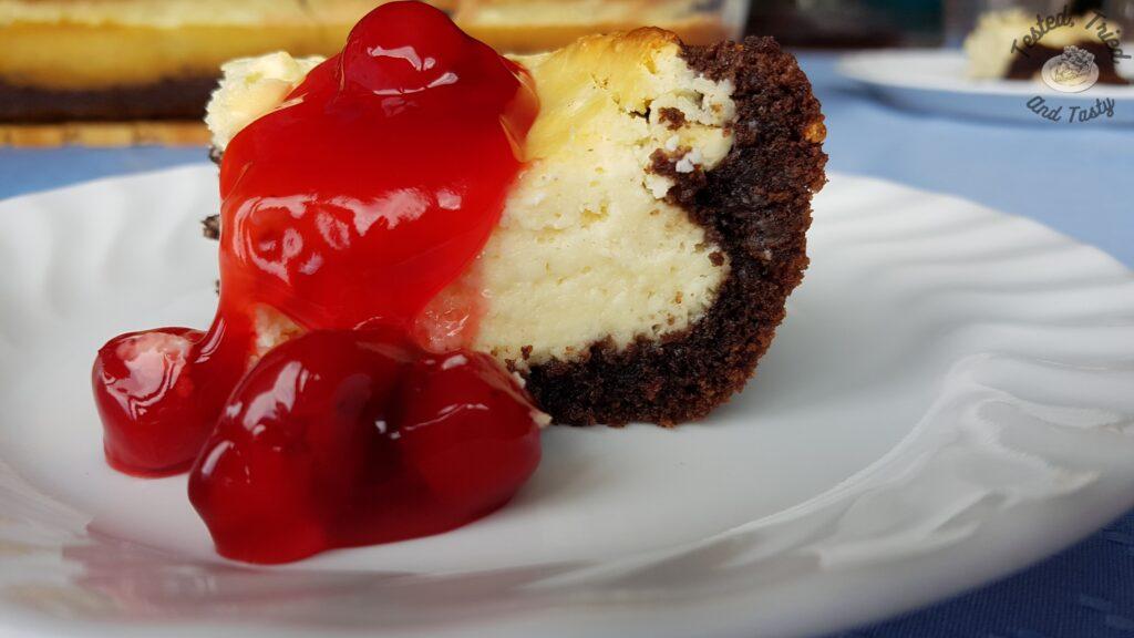 Black Forest cheesecake cake with cherry pie filling on top.