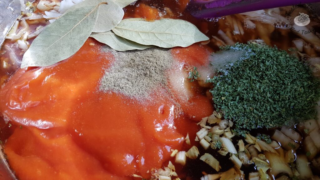 Bay leaves, thyme, salt, pepper and sugar added to soup in a large saucepan.