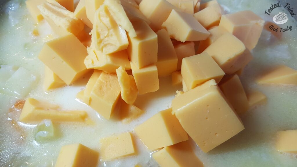 Velveeta chunks added to the fish soup.