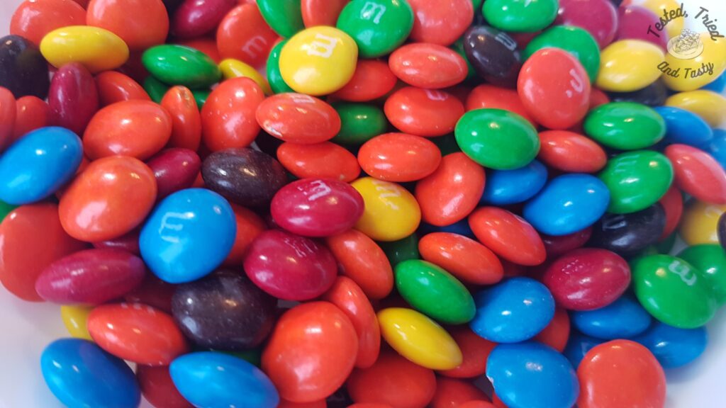 M&Ms in a white bowl.