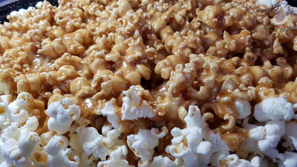 Caramel sauce poured onto popcorn.