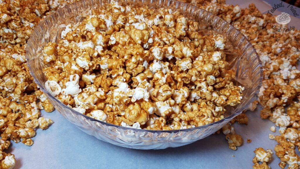 Caramel popcorn in a clear bowl.