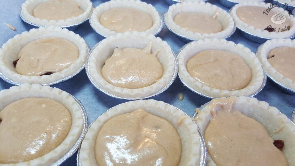 Syrupy filling with raisins in tart shells.