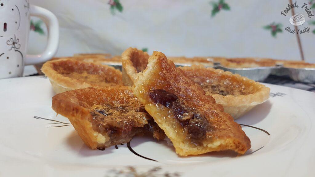 Butter tarts on a christmas plate.