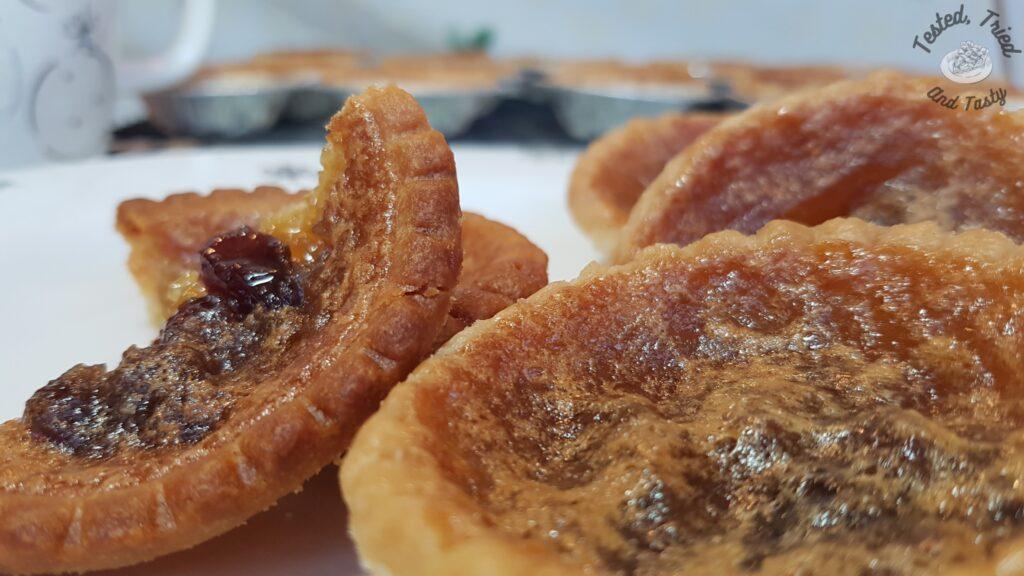 Butter tarts on a christmas plate.
