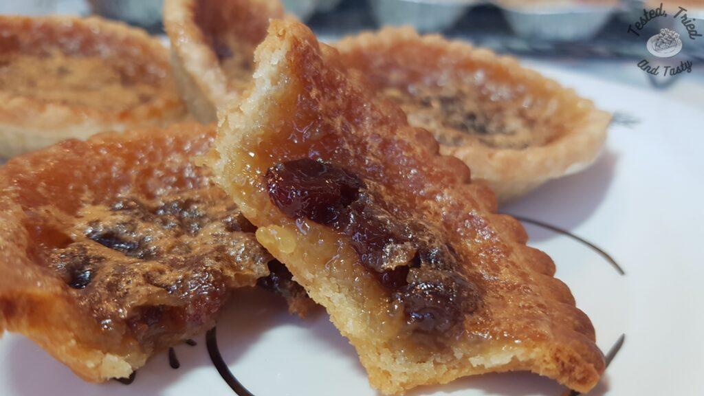 Butter tarts on a christmas plate.