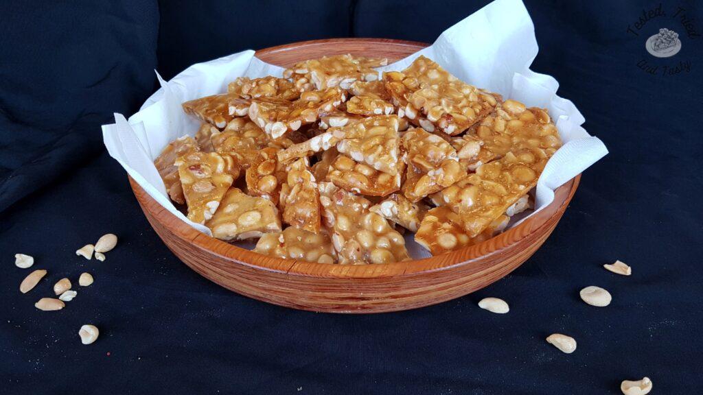 Peanut brittle in a wooden bowl.