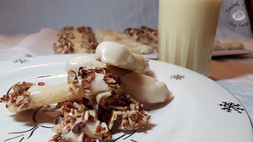 Eggnog log cookies with a glass of eggnog.