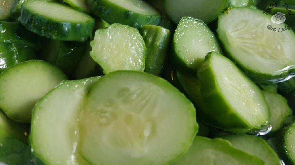 Sliced cucumbers in brine for sweet refrigerator pickles.