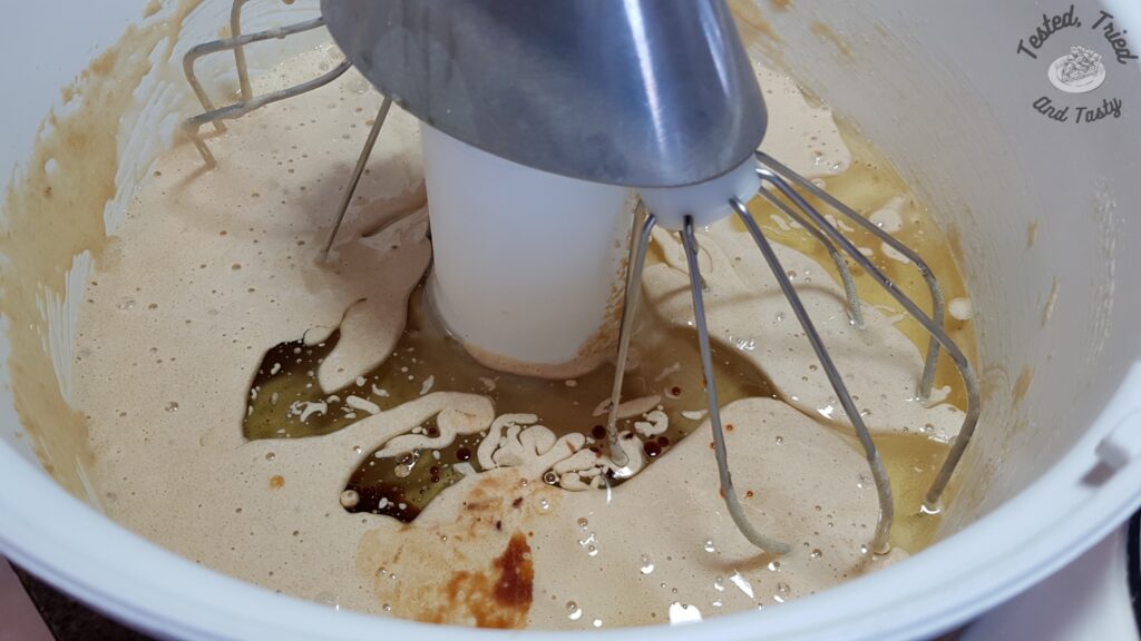 Adding the oil to the liquid ingredients in the bosch mixer.