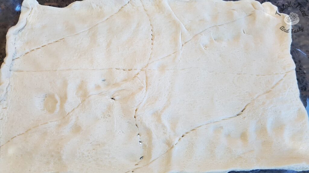 Pillsbury crescent rolls on a baking sheet.