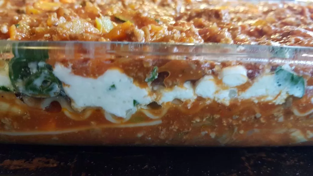 Layers of meat sauce, cottage cheese, and lasagna noodles