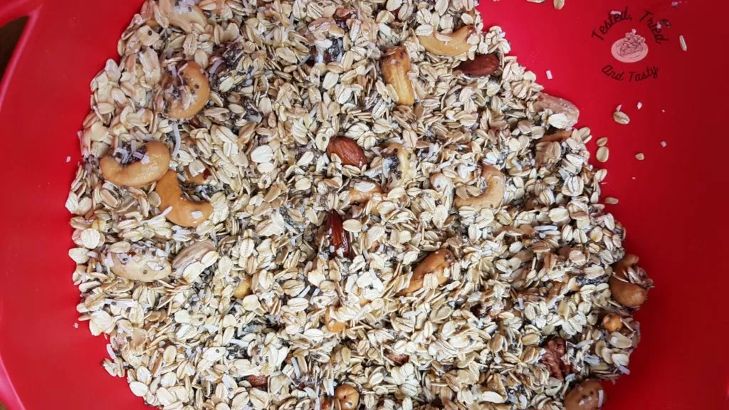 Oats, nuts, coconut, chia seeds in a large bowl.