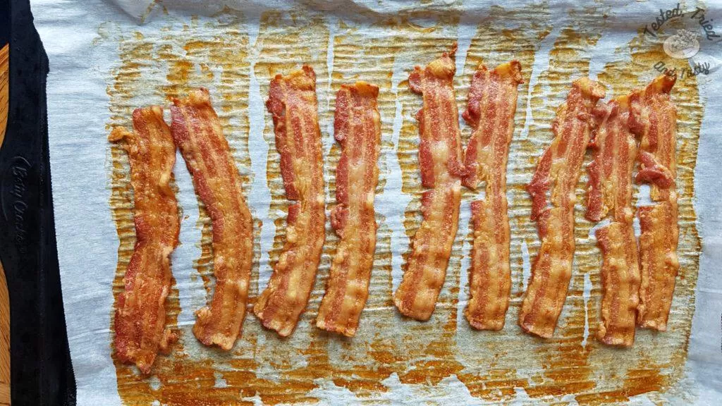 Bacon on a parchment lined baking sheet.