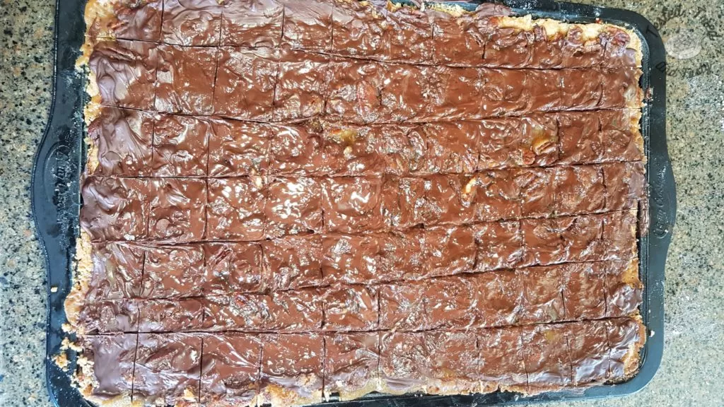 homemade turtle bars on a baking sheet.