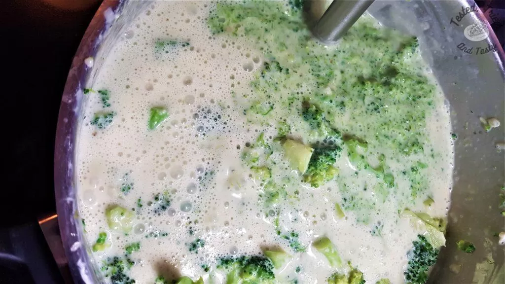 Blending up the broccoli cheddar soup with a hand blender.