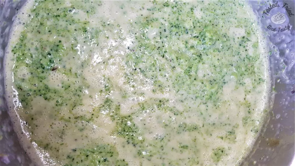 homemade cream of broccoli soup simmering in pan.