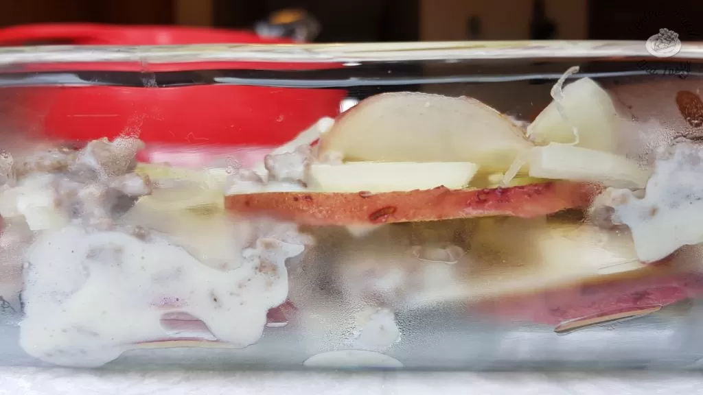 layers of potato, onion, and beefy bechamel sauce