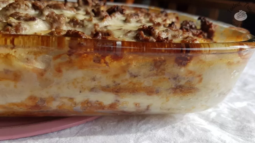 Beefy Scalloped Potatoes on a white tablecloth.