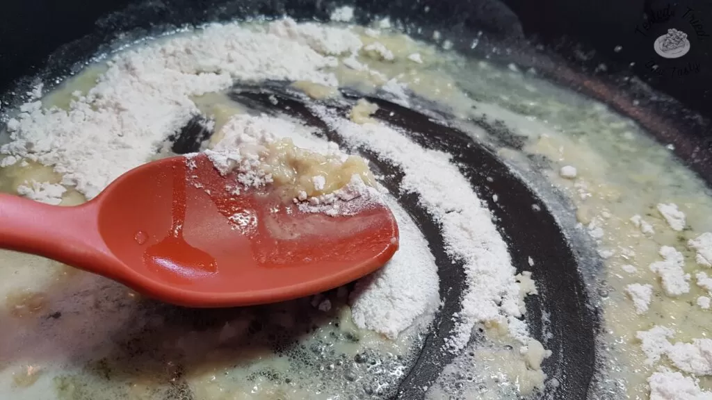 Flour added and stirred into the butter and garlic mixture in a large saucepan.