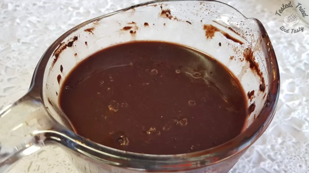 Liquid ingredients for hot fudge chocolate cake in a measuring cup.