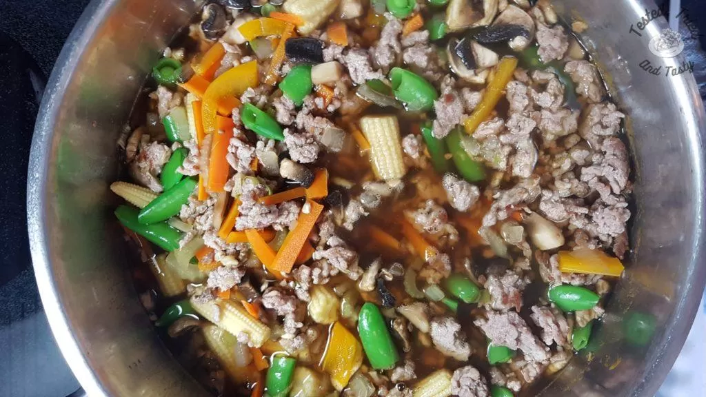 Sugar snaps, baby corn, and mushrooms added to asian pork and noodle soup.