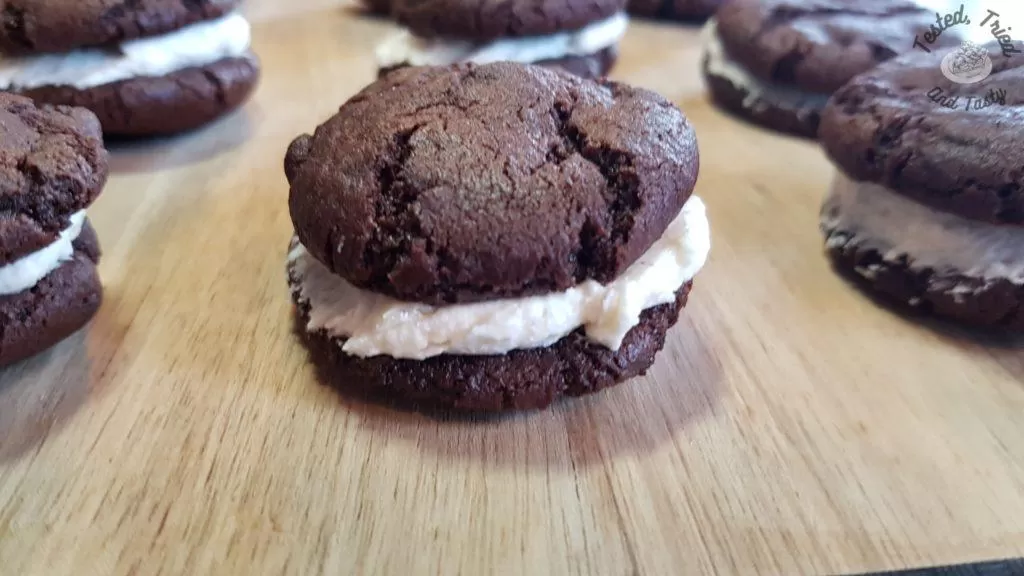 Homemade oreo cookies on a wooden cutting board. on a woode