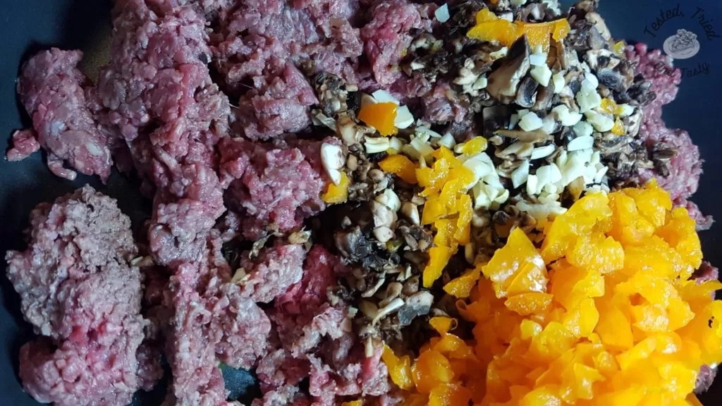 ground beef, bell pepper, mushrooms chopped for delicious perogy casserole.